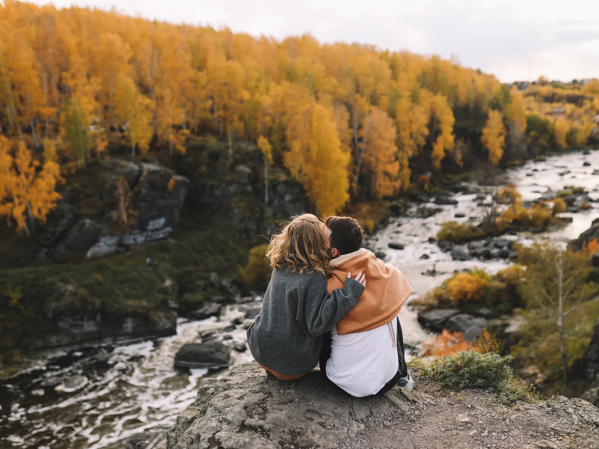 Outdoorsy couple hiking in mountains, sharing adventurous spirit and love for nature, ideal for outdoor dating sites, finding companionship for hiking, camping, wilderness exploration on BadsX.com.