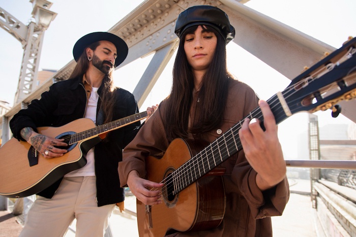 Music lovers at concert, sharing diverse musical tastes, finding harmony and rhythm in relationship, ideal for music dating sites like BadsX.com.
