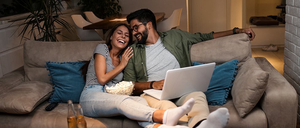 Tech couple enjoying gadgets and coding, finding intellectual connection on tech dating site, meeting partners who share curiosity for AI, software, and digital innovation on BadsX.com.