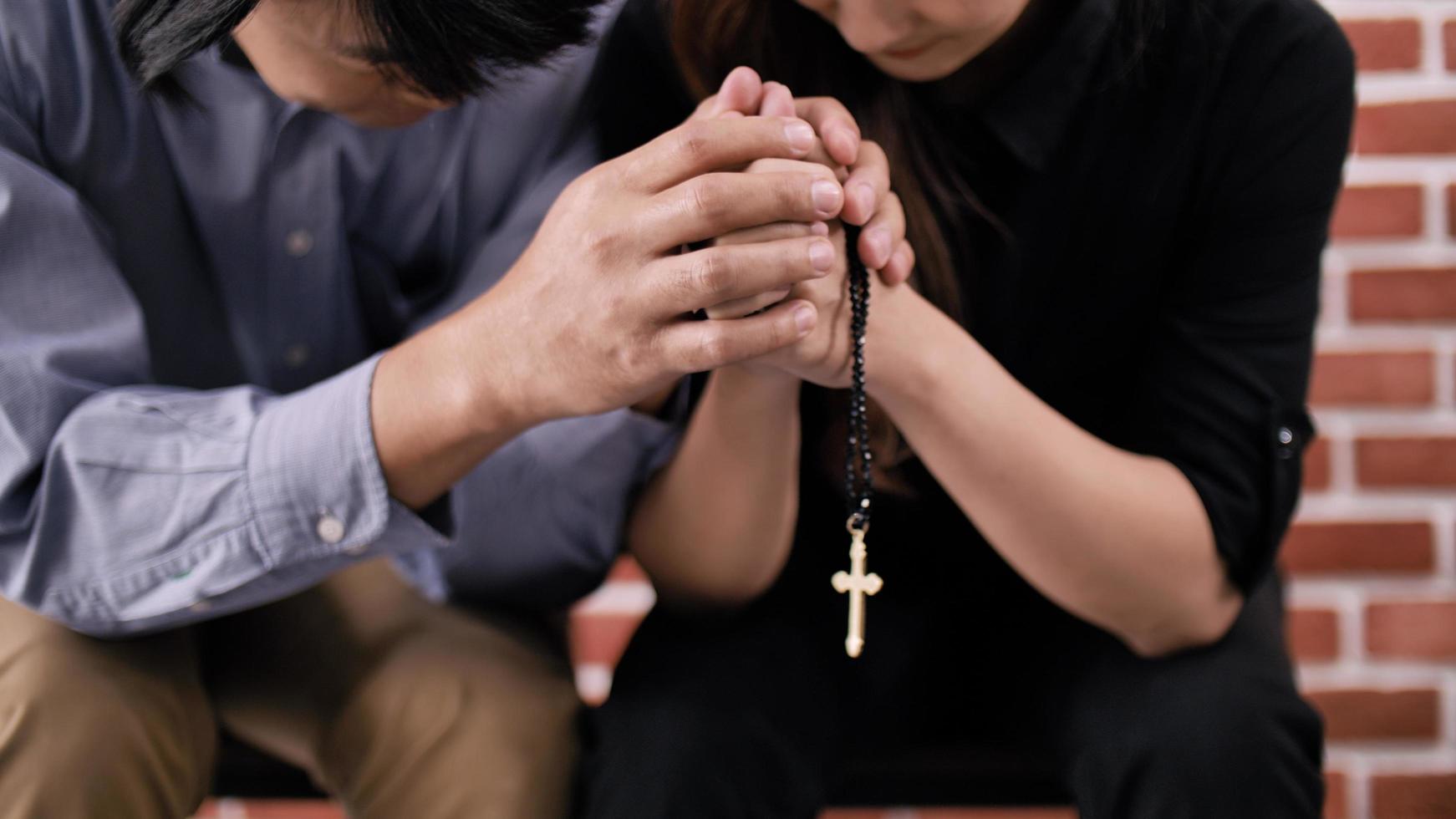 Christian couple praying, symbolizing faith-based relationship, finding spiritual connection on dating site, building life rooted in shared beliefs and divine love on BadsX.com.